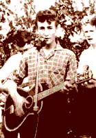 John Lennon playing with The Quarrymen. This was John first real band and for a time, it was the nucleus of The Beatles, once Paul McCartney and George Harrison joined the group.